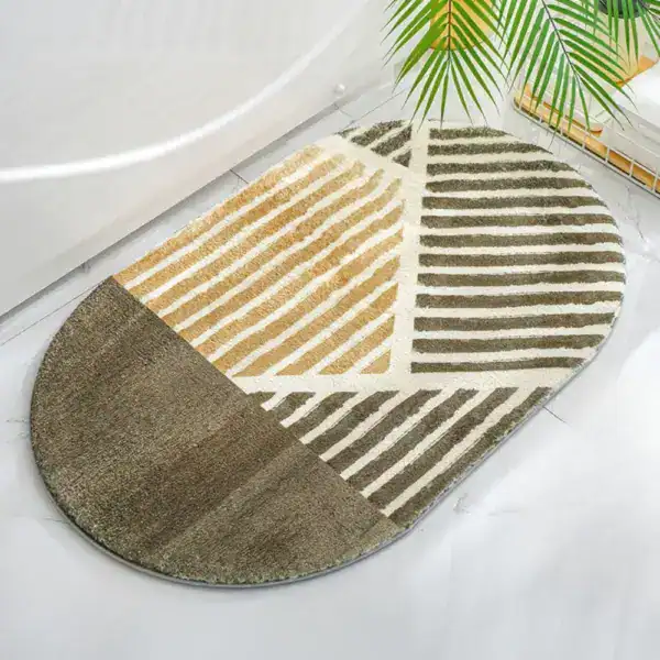 Alfombra de baño ovalada con diseño geométrico en tonos marrones y beige.