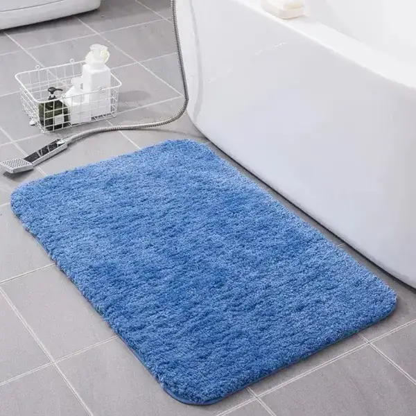 Alfombra de baño suave azul en baño moderno.